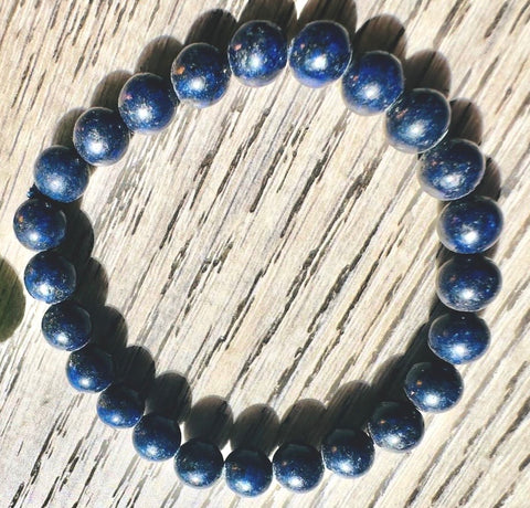 Blue beaded bracelet on a wooden surface