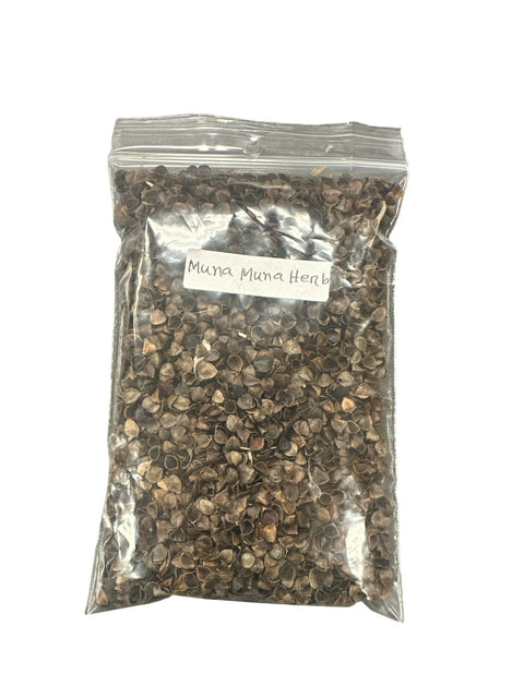 Clear plastic bag filled with dried herbs labeled 'Muna Muna Herbs' on a white background