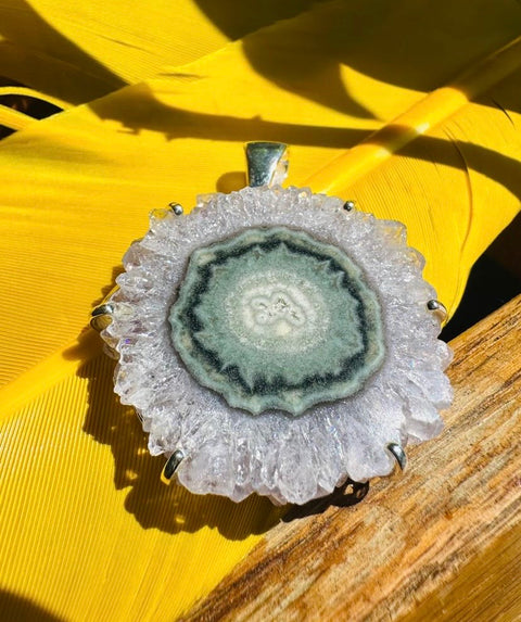 Geode-style pendant on a yellow leaf background
