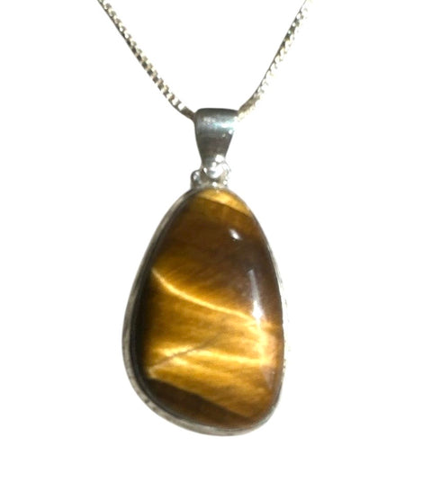 Tiger's eye pendant on a silver chain against a white background