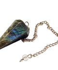 Labradorite crystal pendulum on a chain with a white background