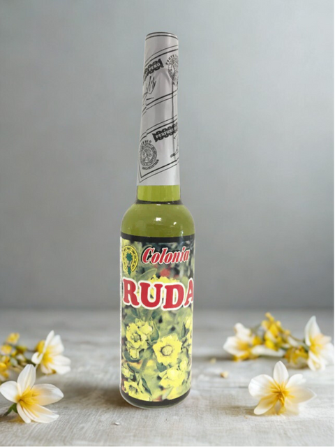 Bottle of Colonia Ruda with floral decorations on a gray background
