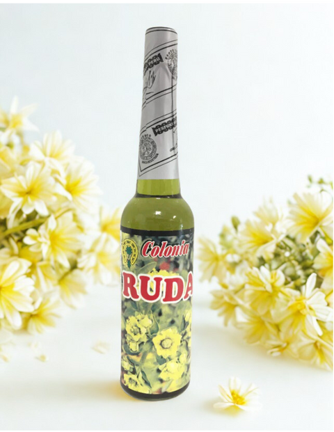 Bottle of Colonia Ruda with yellow flowers on a white background
