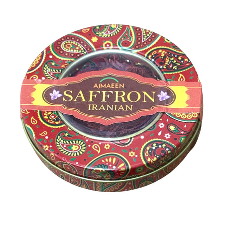 Round tin container of Ajmaeen Iranian Saffron with colorful design on a white background