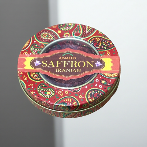 Decorative tin of Aimaen Saffron Iranian on a gray background