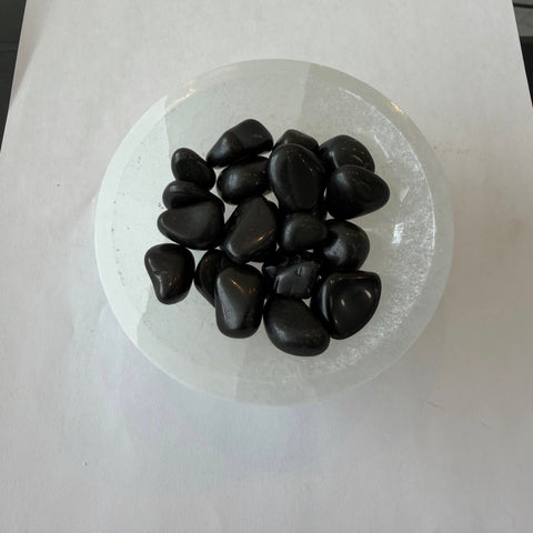 Black Tourmaline Tumbled Stones — polished black crystals for Root Chakra, grounding, and shielding energy.