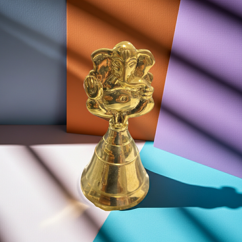 Brass bell featuring an engraved Ganesha design for पूजा room decor.