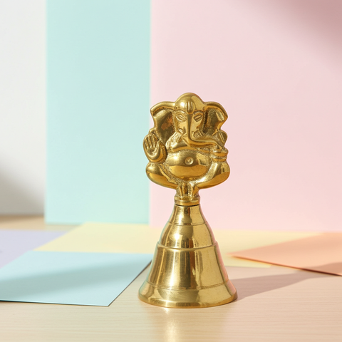 Decorative brass bell with detailed Ganesha design for home mandir decoration.