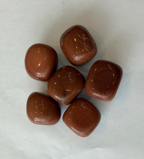 Goldstone Tumbled Stones group — glittering copper-gold crystals for motivation and positive energy.