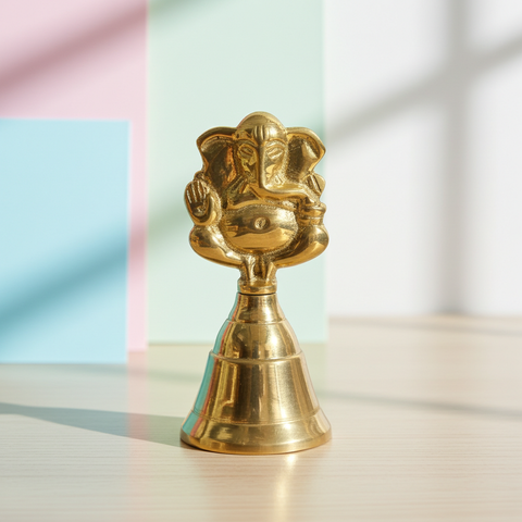 Handcrafted brass bell adorned with Ganesha artwork for spiritual ceremonies.