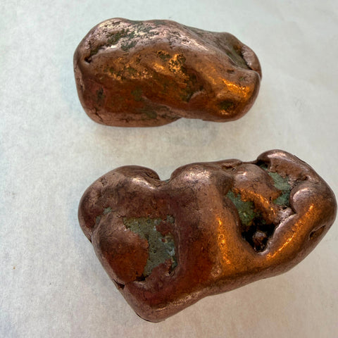 Native copper nuggets showing metallic shine and green oxidation detail