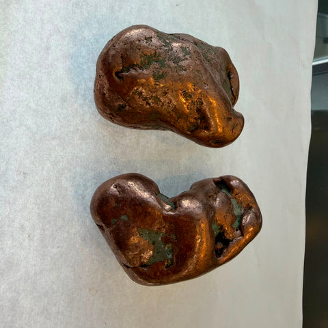 Native copper nuggets with green patina patches and smooth water-worn shape
