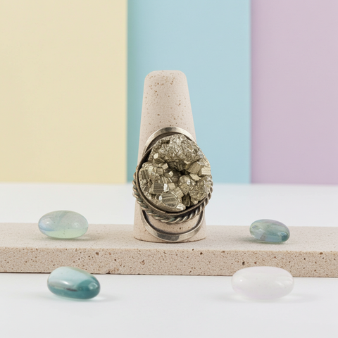Natural pyrite crystal ring with an adjustable fit and rugged organic texture.