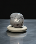     Polished Howlite tumbled stone with white body and gray veining for gemstone collecting and decorative display.
