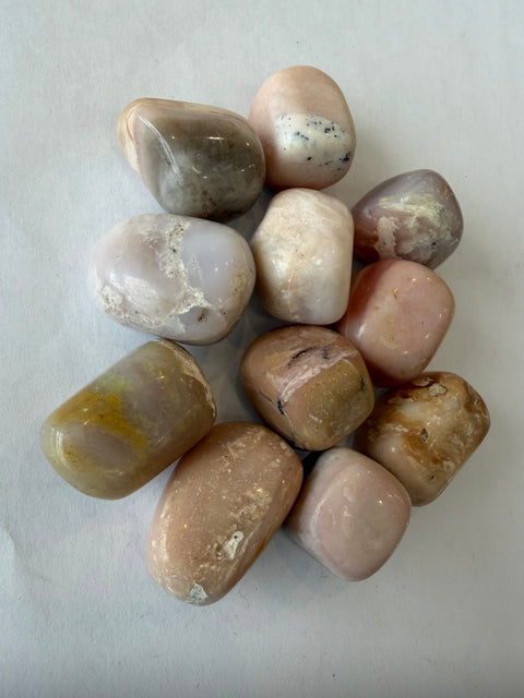 Pink Opal Tumbled Stones group — natural polished crystals for self-love, comfort, and meditation.