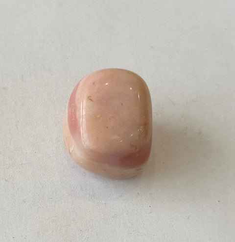 Pink Opal Tumbled Stones in selenite bowl — soft pink crystals for Heart Chakra balance and stress relief.