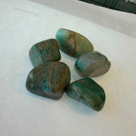 Natural amazonite tumbled stone showing blue-green feldspar coloring