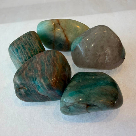 Polished amazonite stone showing blue-green color and natural matrix veining