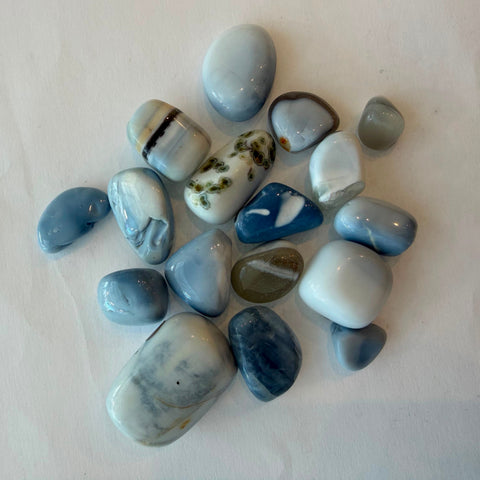 Blue opal tumbled stone showing pale blue and grey marbling
