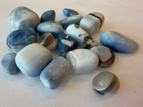 Natural blue opal tumbled stone with soft blue and white coloring