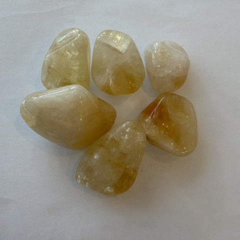 Citrine tumbled stone showing warm honey-gold color and glassy polish