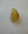 Natural citrine quartz tumbled stone in golden-yellow tones