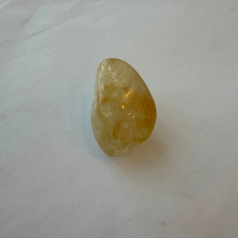 Natural citrine quartz tumbled stone in golden-yellow tones