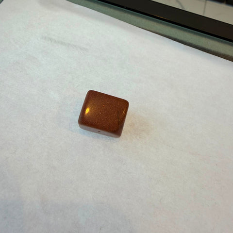Group of polished goldstone tumbled stones showing dense golden copper glitter