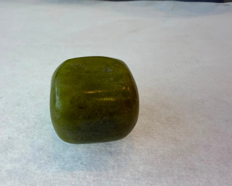 Olive jade tumbled stones showing natural green color variation