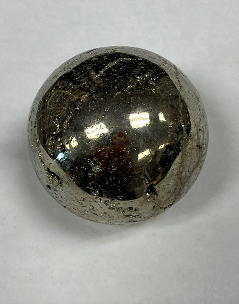 Polished pyrite stone sphere for meditation practice, energy work, and desk decoration.