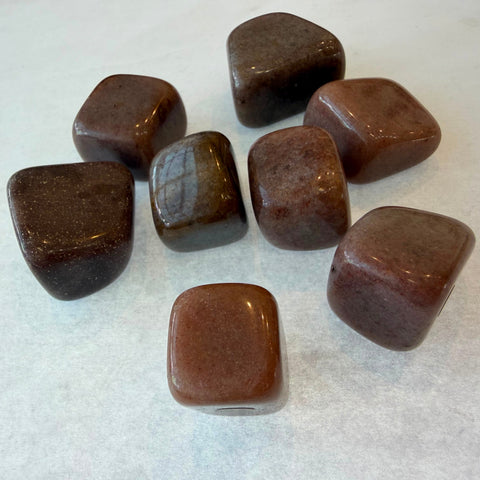 Polished red aventurine stone showing warm russet coloring and glossy finish