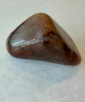 Group of polished red aventurine tumbled stones showing natural color variation