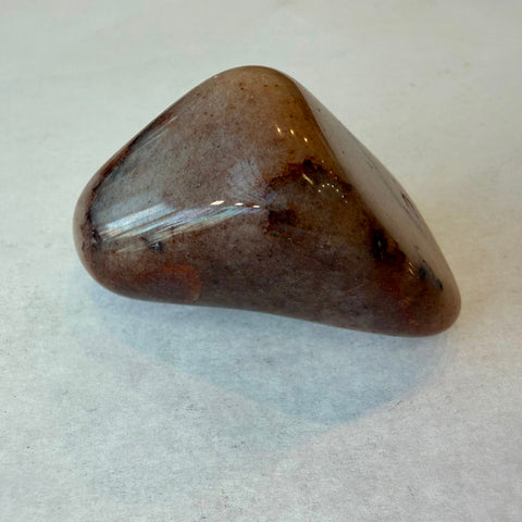Group of polished red aventurine tumbled stones showing natural color variation