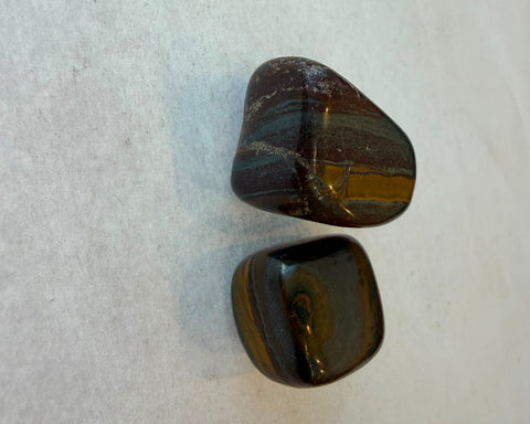 Tiger Iron stone showing golden tiger's eye bands against red and grey layers