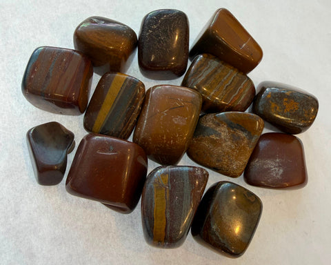 Polished Tiger Iron tumbled stones with gold, red, and grey chatoyant bands