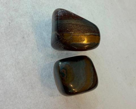Group of polished Tiger Iron stones showing natural banding variation