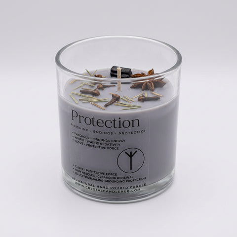 Protection Intention Candle angled view – lavender-grey hand poured glass jar with black tourmaline and cloves on top