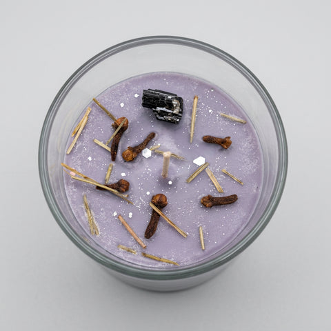 Protection Intention Candle top view – clove, pine needles and raw black tourmaline crystal