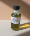 Pure olive carrier oil displayed in a clean cosmetic bottle.