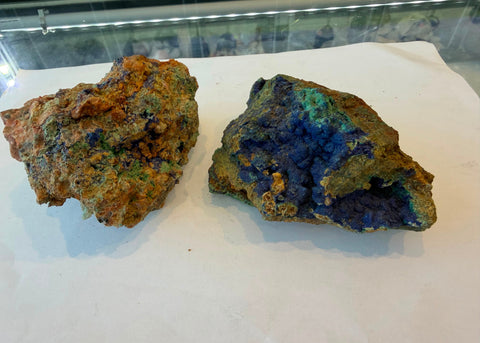 Selection of raw Azurite with Malachite specimens in blue and green on tan matrix