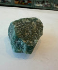 Single raw Green Aventurine stone with mottled green coloring and mica sparkle