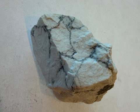 Raw Howlite specimen with marbled white surface and dark vein patterning