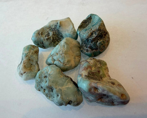 Raw Larimar stone showing natural blue pectolite coloring and surface texture