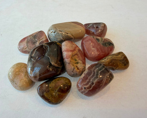 Rhodochrosite specimen showing botryoidal scalloped layering and glossy polish