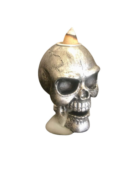 Skull backflow incense burner with dramatic dark atmospheric mist through skull forms