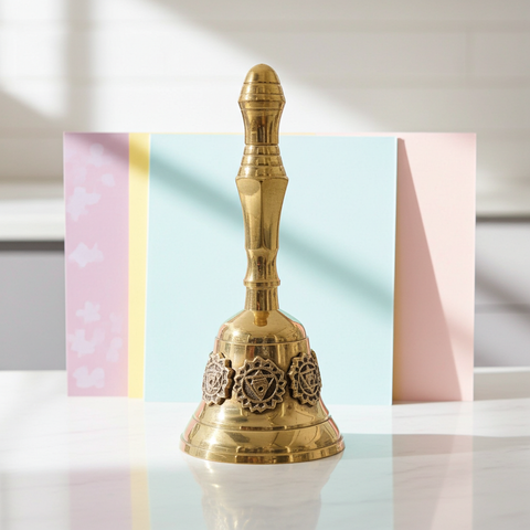 Spiritual brass bell with detailed seven chakra engraving.