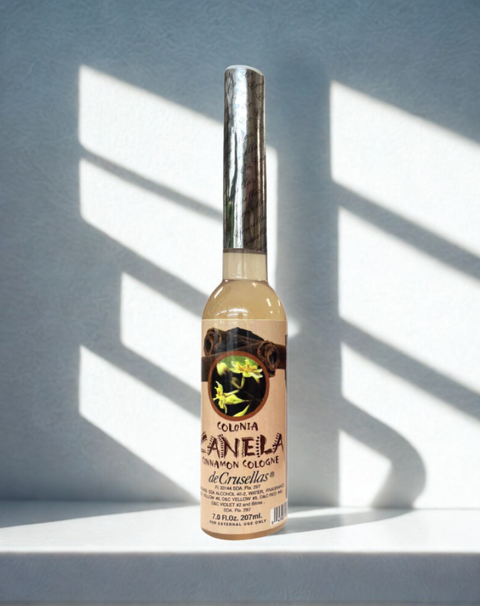 Bottle of cinnamon spiritual water displayed for altar use, blessings, and ritual work.