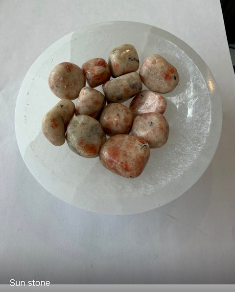 Sunstone Tumbled Stones group — polished warm crystals for optimism, motivation, and Solar Plexus Chakra.